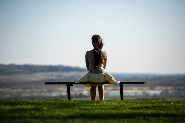 woman sitting at the beach alone
