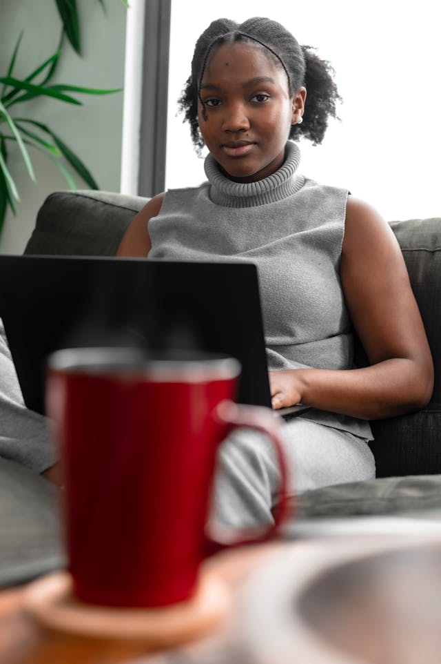 woman sitting with laptop with coffee mug